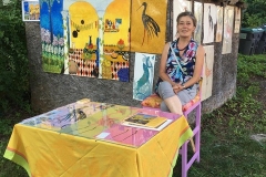 Artist with her work on Beekman St.